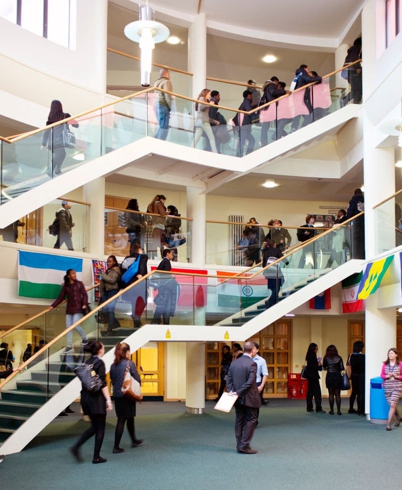 Students and staff on the staircases of a school atrium